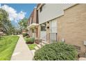 Charming townhome with brick and siding, showcasing front yard landscaping and pedestrian walkway at 12885 W Alameda Dr, Lakewood, CO 80228