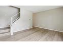 Bright living room featuring hardwood floors, a staircase, and a neutral color palette at 12885 W Alameda Dr, Lakewood, CO 80228