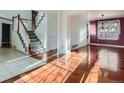 Bright living room featuring hardwood floors, staircase and abundant natural light at 17045 Hastings Ave, Parker, CO 80134