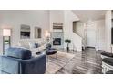 Cozy living room featuring a fireplace, modern decor, and ample natural light at 3611 S Perth Cir # 103, Aurora, CO 80013