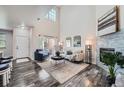 Bright living room boasts high ceilings, fireplace, and seamless access to the outdoor patio at 3611 S Perth Cir # 103, Aurora, CO 80013