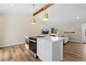 Kitchen island featuring built-in stainless steel oven and additional counter space, open to living area at 18866 W 59Th Pl, Golden, CO 80403