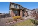 Attractive two-story home with a covered front porch and nicely arranged landscaping at 26909 E Cedar Ave, Aurora, CO 80018