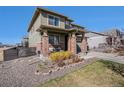 Charming front porch welcomes you to this beautiful home with landscaped garden and space for outdoor seating at 26909 E Cedar Ave, Aurora, CO 80018