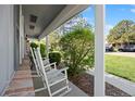 Cozy front porch with rocking chairs, perfect for relaxing outdoors at 2608 E Fremont Pl, Centennial, CO 80122