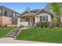 Charming bungalow with inviting front porch and well-manicured lawn at 853 Saint Paul St, Denver, CO 80206