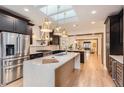 Modern kitchen featuring stainless steel appliances, large island, and ample counter space at 853 Saint Paul St, Denver, CO 80206
