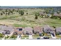 This aerial view showcases the community's proximity to open green spaces, trails, and other homes in a picturesque setting at 11890 Discovery Cir, Parker, CO 80138