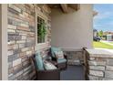Inviting front porch featuring stone accents, comfortable seating, and a decorative wreath, perfect for relaxing outdoors at 11890 Discovery Cir, Parker, CO 80138