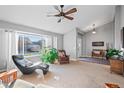 Cozy living room featuring vaulted ceilings, neutral carpet, and a large picture window with natural lighting at 4530 Ridgewood Ct, Castle Rock, CO 80109