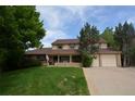 Attractive two-story house featuring a covered porch and well-maintained lawn at 8130 E Bethany Pl, Denver, CO 80231