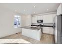 Modern kitchen with white cabinets, quartz countertops, and stainless steel appliances at 5604 Wisteria Ave, Firestone, CO 80504