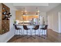 Modern kitchen with breakfast bar and wood cabinets at 2200 S University Blvd # 201, Denver, CO 80210