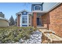 Welcoming front entrance with brick accents, a bay window, and well-maintained landscaping at 2105 Keota Ln, Superior, CO 80027