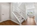 Carpeted staircase with white railing leads to the upper level of the house at 1632 Saddlesmith Pl, Castle Pines, CO 80108