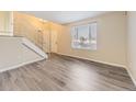 An inviting living room boasting stylish laminate flooring, and a staircase with metal railing at 3027 S Jasper Way, Aurora, CO 80013