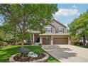 Charming two-story home with a three-car garage, mature landscaping, and a basketball hoop at 5046 Sage Brush Dr, Broomfield, CO 80023