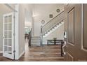 Welcoming foyer with wood floors, staircase, and view into the dining room at 5046 Sage Brush Dr, Broomfield, CO 80023