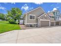Exterior view of home with a two-car garage and stone accents at 11268 Grove St # I, Westminster, CO 80031