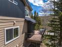 Outdoor deck with dining table and chairs with wooded and neighborhood views at 100 River Park Dr # A, Breckenridge, CO 80424