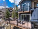 Outdoor deck space with chairs and dining table overlooking serene natural surroundings at 100 River Park Dr # A, Breckenridge, CO 80424
