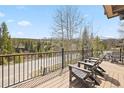Mountain view from deck with outdoor furniture overlooking green trees at 100 River Park Dr # A, Breckenridge, CO 80424