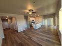 Spacious living room with hardwood floors, a ceiling fan, and lots of natural light at 48250 Shetland Dr, Bennett, CO 80102