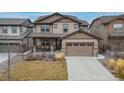 Charming two-story house with a welcoming front porch and a well-maintained lawn at 8827 Gore St, Arvada, CO 80007