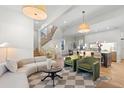 Spacious living room featuring a modern, open-concept layout with a kitchen and staircase at 817 29Th St, Denver, CO 80205