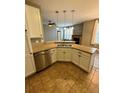 Kitchen island with double sink and granite countertop at 17443 Nature Walk Trail # 102, Parker, CO 80134