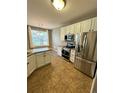 Kitchen features stainless steel appliances and an island at 17443 Nature Walk Trail # 102, Parker, CO 80134