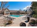 Relaxing community pool area with lounge chairs, perfect for enjoying sunny days and socializing with neighbors at 12931 Ironstone Way # 303, Parker, CO 80134