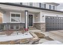 Welcoming front entrance with a cozy porch and a well-maintained garden at 4384 S Johnson Ct, Littleton, CO 80123