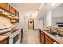 Well-lit kitchen with matching appliances, a double sink, and wooden countertops at 1074 S Dearborn St # 108, Aurora, CO 80012