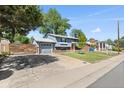 Inviting two-story home featuring a well-manicured lawn, driveway, and lush trees at 4381 Dixon Dr, Westminster, CO 80031