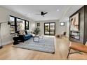 Bright living room with hardwood floors, modern fireplace, and a walkout to balcony at 2162 S Ash St, Denver, CO 80222