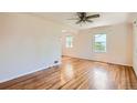 Bright living room featuring hardwood floors and natural light from plentiful windows at 1140 S Xavier St, Denver, CO 80219