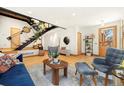 Cozy living room with hardwood floors, modern staircase, stylish seating, and bright natural light at 2937 Champa St # A, Denver, CO 80205