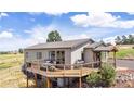 Elevated home showcasing large deck and surrounding landscape at 8408 Vinegarroon Rd, Parker, CO 80138