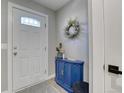 Cozy entryway features a blue cabinet with wreath, adding charm to the home at 1811 S Quebec Way # 103, Denver, CO 80231