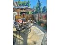 Inviting outdoor patio with comfortable seating, shade umbrella, and decorative accents for relaxed outdoor living at 12592 E Cornell Cir, Aurora, CO 80014