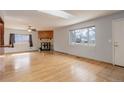 Bright living room featuring gleaming hardwood floors, a cozy fireplace, and a flood of natural light at 1056 S Macon Way, Aurora, CO 80012