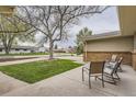 Cozy front porch with seating area overlooking the landscaped yard and neighborhood street at 8102 S Carr Ct, Littleton, CO 80128