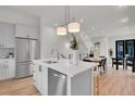 Modern kitchen with island, stainless steel appliances, and white cabinets at 9055 Westminster Blvd, Westminster, CO 80031