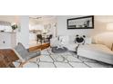 Inviting living room showcasing a white sectional sofa, modern rug, and open access to the dining area at 601 W 11Th Ave # 1101, Denver, CO 80204