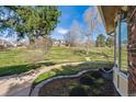 A view of a well-manicured lawn and green space beyond the home's maintained yard at 7641 S Rosemary Cir, Centennial, CO 80112