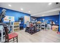 Finished basement with a desk, chairs, shelving, and white-board work area at 6581 W Alamo Dr, Littleton, CO 80123