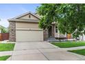 A home with a wide driveway, well-maintained lawn and inviting front porch at 6581 W Alamo Dr, Littleton, CO 80123