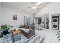 Sun-filled living area with high ceilings, lots of natural light, a ceiling fan, and a dining area with views of the outdoors at 9680 Brentwood Way # 202, Broomfield, CO 80021