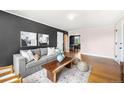 Open-concept living room with a cozy sofa, hardwood floors, and an inviting atmosphere at 1321 E 10Th Ave # 4, Denver, CO 80218